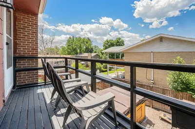 two chairs sitting on the balcony of a house at All-In-One Retreat Spa, Gym, Fun Room & Location! in Arvada