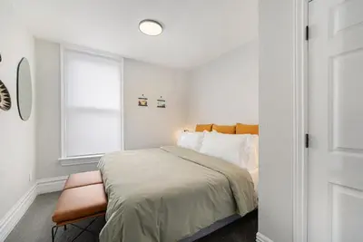 a small bedroom with a bed and a window at Outdoor Living and comfort by RiNo BBQ Office in Denver