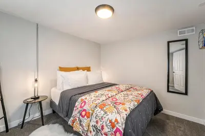 a small bedroom with a bed and a mirror at Outdoor Living and comfort by RiNo BBQ Office in Denver