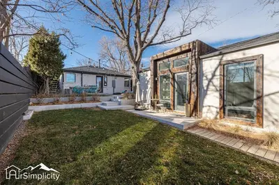 a home with a greenhouse and a yard at Sunnyside guesthouse near Rocky Mountain Lake in Denver