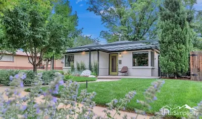 a house with a garden in front of it at Sunnyside guesthouse near Rocky Mountain Lake in Denver