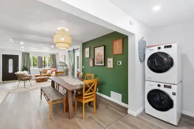 a kitchen and dining room with a table and a washing machine at Modern Family Home Rooftop Patio Game Room in Denver