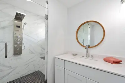 a white bathroom with a sink and a mirror at Modern Family Home Rooftop Patio Game Room in Denver