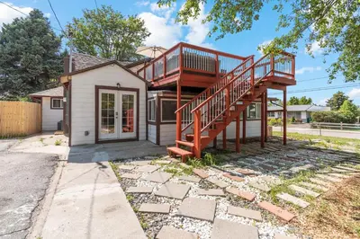 a house with a deck and a staircase at Modern Family Home Rooftop Patio Game Room in Denver