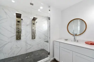 a white bathroom with a shower and a sink at Modern Family Home Rooftop Patio Game Room in Denver