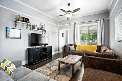 a living room with two couches and a tv at Work-Friendly Denver Stay - Rooftop Deck & Garden in Denver