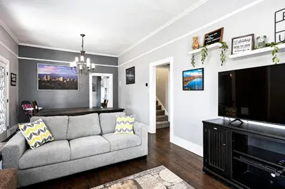 a living room with a couch and a flat screen tv at Work-Friendly Denver Stay - Rooftop Deck & Garden in Denver
