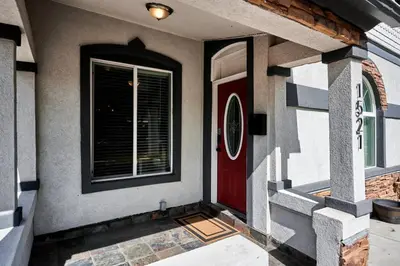 a house with a red door and a window at Work-Friendly Denver Stay - Rooftop Deck & Garden in Denver