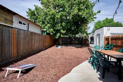 a patio with a table and chairs and a fence at Work-Friendly Denver Stay - Rooftop Deck & Garden in Denver