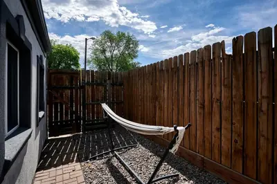 a hammock sitting in front of a wooden fence at Work-Friendly Denver Stay - Rooftop Deck & Garden in Denver