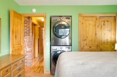 a washer and dryer in a room with green walls at Riverside Condo in Downtown Winter Park! in Winter Park