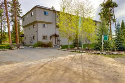 a large building with a driveway in front of it at Riverside Condo in Downtown Winter Park! in Winter Park