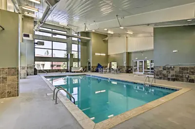 a large swimming pool in a large building at Riverside Condo in Downtown Winter Park! in Winter Park