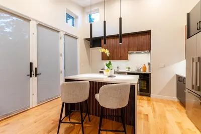 a kitchen with a island with two stools at 30-Day Minimum Boulder Bright & Modern Private 1BR 2BA ADU in Boulder