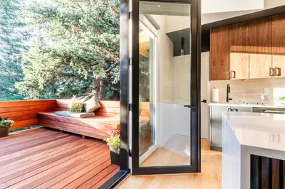 a kitchen with a sliding glass door leading to a deck at 30-Day Minimum Boulder Bright & Modern Private 1BR 2BA ADU in Boulder