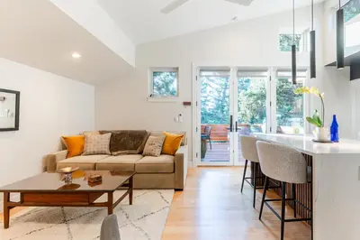 a living room and kitchen with a couch and a table at 30-Day Minimum Boulder Bright & Modern Private 1BR 2BA ADU in Boulder