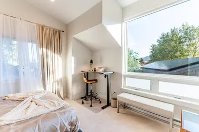 a bedroom with a bed and a desk and a window at 30-Day Minimum Boulder Bright & Modern Private 1BR 2BA ADU in Boulder