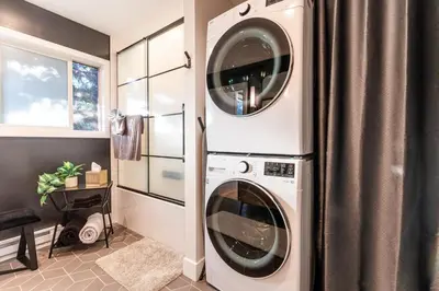 a laundry room with a washer and dryer at 30-Day Minimum Boulder Bright & Modern Private 1BR 2BA ADU in Boulder