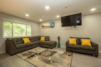 a living room with a couch and a flat screen tv at Close to Downtown Sleeps 8 Private Backyard in Arvada