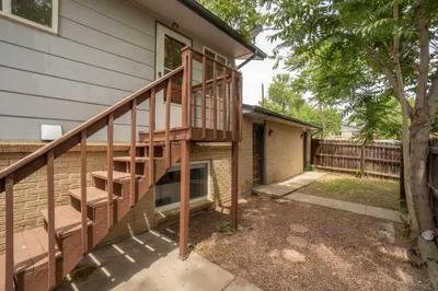 a wooden staircase next to a house at Close to Downtown Sleeps 8 Private Backyard in Arvada