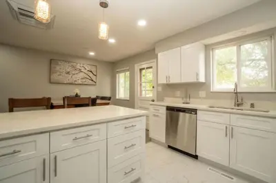 a kitchen with white cabinets and a counter top at Close to Downtown Sleeps 8 Private Backyard in Arvada