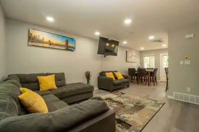 a living room with a couch and a dining room at Close to Downtown Sleeps 8 Private Backyard in Arvada