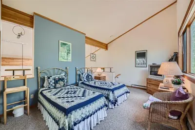 a bedroom with two beds and a tv at 2151 The Pines condo in Keystone