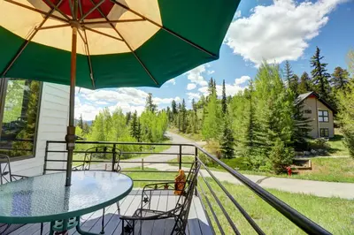 a table and chairs on a balcony with an umbrella at 195 Summerwood home in Dillon