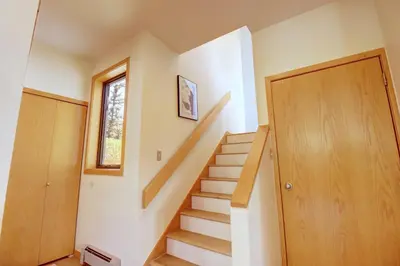 a staircase in a house with a wooden door at 195 Summerwood home in Dillon