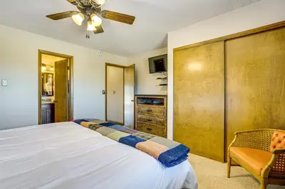 a bedroom with a bed and a ceiling fan at 6 Mi to Winter Park Resort Fraser Condo with Pool in Fraser