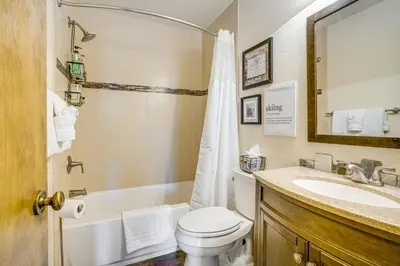a bathroom with a toilet and a sink at 6 Mi to Winter Park Resort Fraser Condo with Pool in Fraser