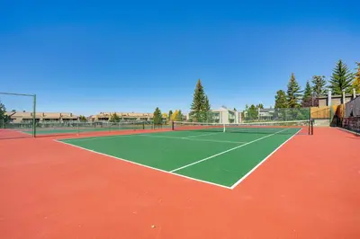 a tennis court with a tennis net on it at 6 Mi to Winter Park Resort Fraser Condo with Pool in Fraser