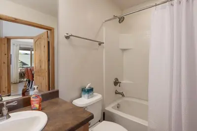 a bathroom with a sink and a toilet and a bath tub at Trailhead Lodge 621 condo in Winter Park