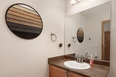 a bathroom with a sink and a mirror at Trailhead Lodge 621 condo in Winter Park