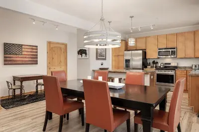 a kitchen and dining room with a table and chairs at Trailhead Lodge 621 condo in Winter Park