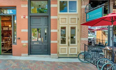 a store with two tables and a red umbrella at NEW! Modern Scandinavian Loft in Old Town Square in Fort Collins