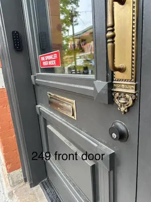 a front door with a front door sign on it at NEW! Modern Scandinavian Loft in Old Town Square in Fort Collins