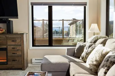a living room with a couch and a large window at 2782 Slopeside condo in Keystone