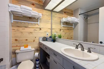 a bathroom with a sink and a toilet and a mirror at 2782 Slopeside condo in Keystone