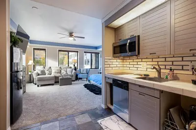 a kitchen with a sink and a living room at 2782 Slopeside condo in Keystone