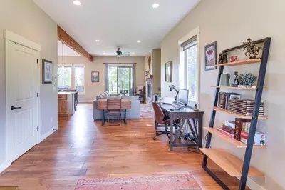 a living room with a table and a desk at Central Fraser Vacation Rental with Private Hot Tub! in Fraser