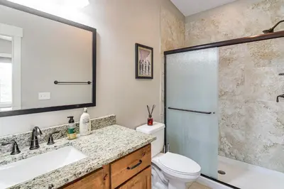 a bathroom with a shower and a toilet and a sink at Central Fraser Vacation Rental with Private Hot Tub! in Fraser