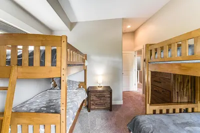 a bedroom with two bunk beds in a house at Central Fraser Vacation Rental with Private Hot Tub! in Fraser