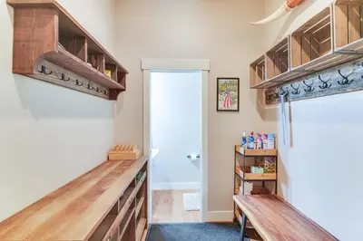 a kitchen with wooden cabinets and a refrigerator at Central Fraser Vacation Rental with Private Hot Tub! in Fraser