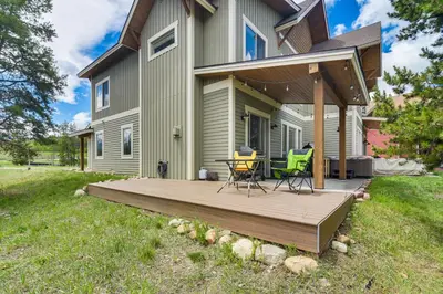 a wooden deck in front of a house at Central Fraser Vacation Rental with Private Hot Tub! in Fraser