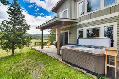 a hot tub on the side of a house at Central Fraser Vacation Rental with Private Hot Tub! in Fraser