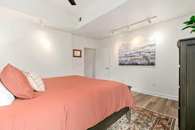 a bedroom with a bed and a painting on the wall at The Cozy Corner Retreat, 15 min walk to Old Town in Fort Collins