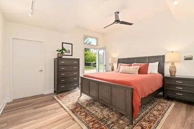 a bedroom with a bed with a red bedspread at The Cozy Corner Retreat, 15 min walk to Old Town in Fort Collins