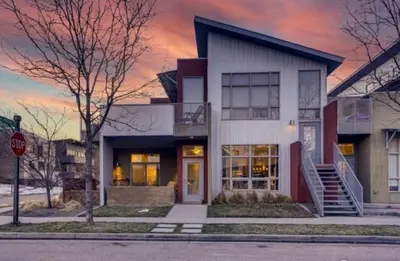 a white building with a sunset in the background at The Cozy Corner Retreat, 15 min walk to Old Town in Fort Collins