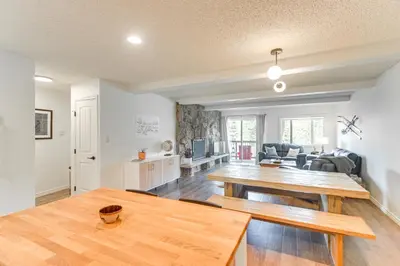 a living room with a table and a couch at Hike, Bike, Ski Winter Park Condo with Deck in Winter Park